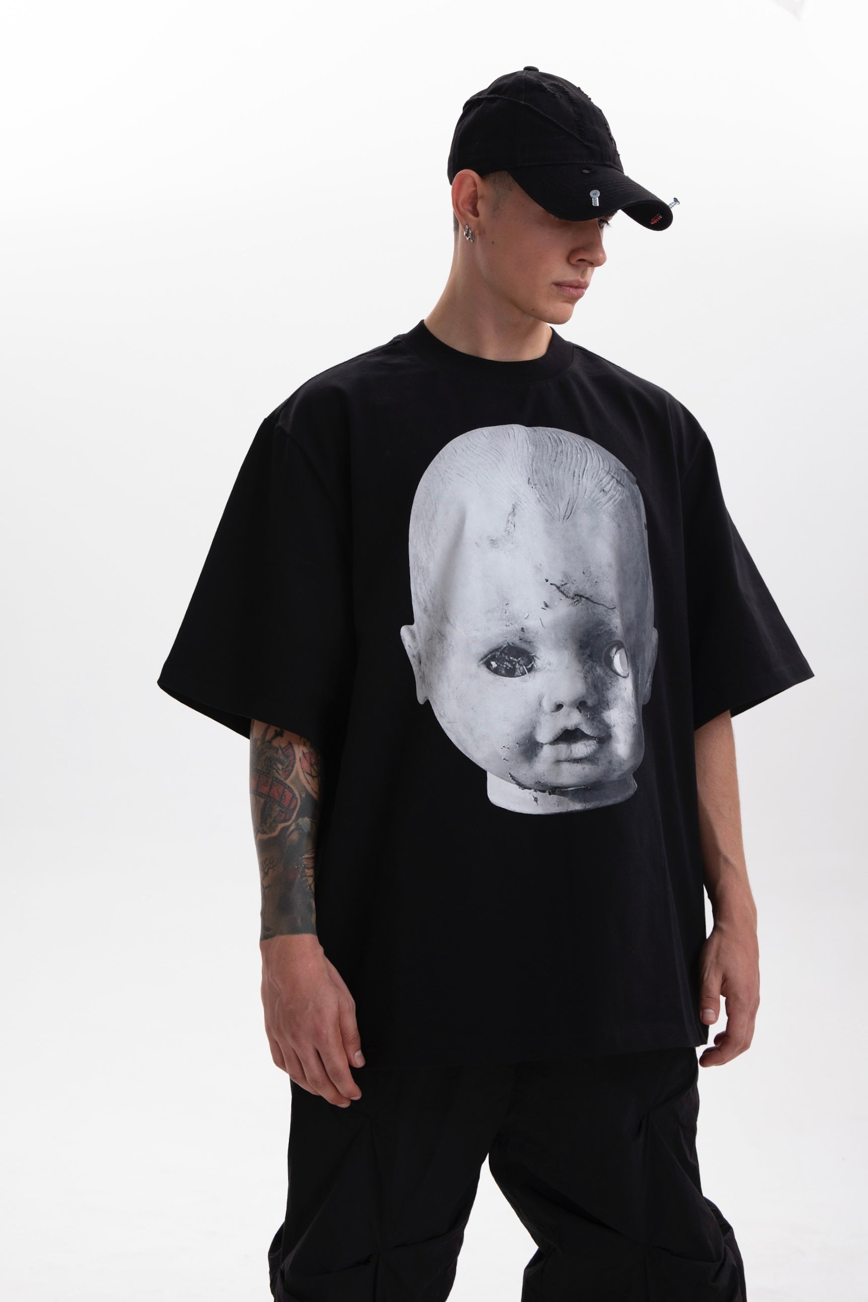Model wearing the Baby Face black heavyweight t-shirt styled in dark aesthetic on a white background