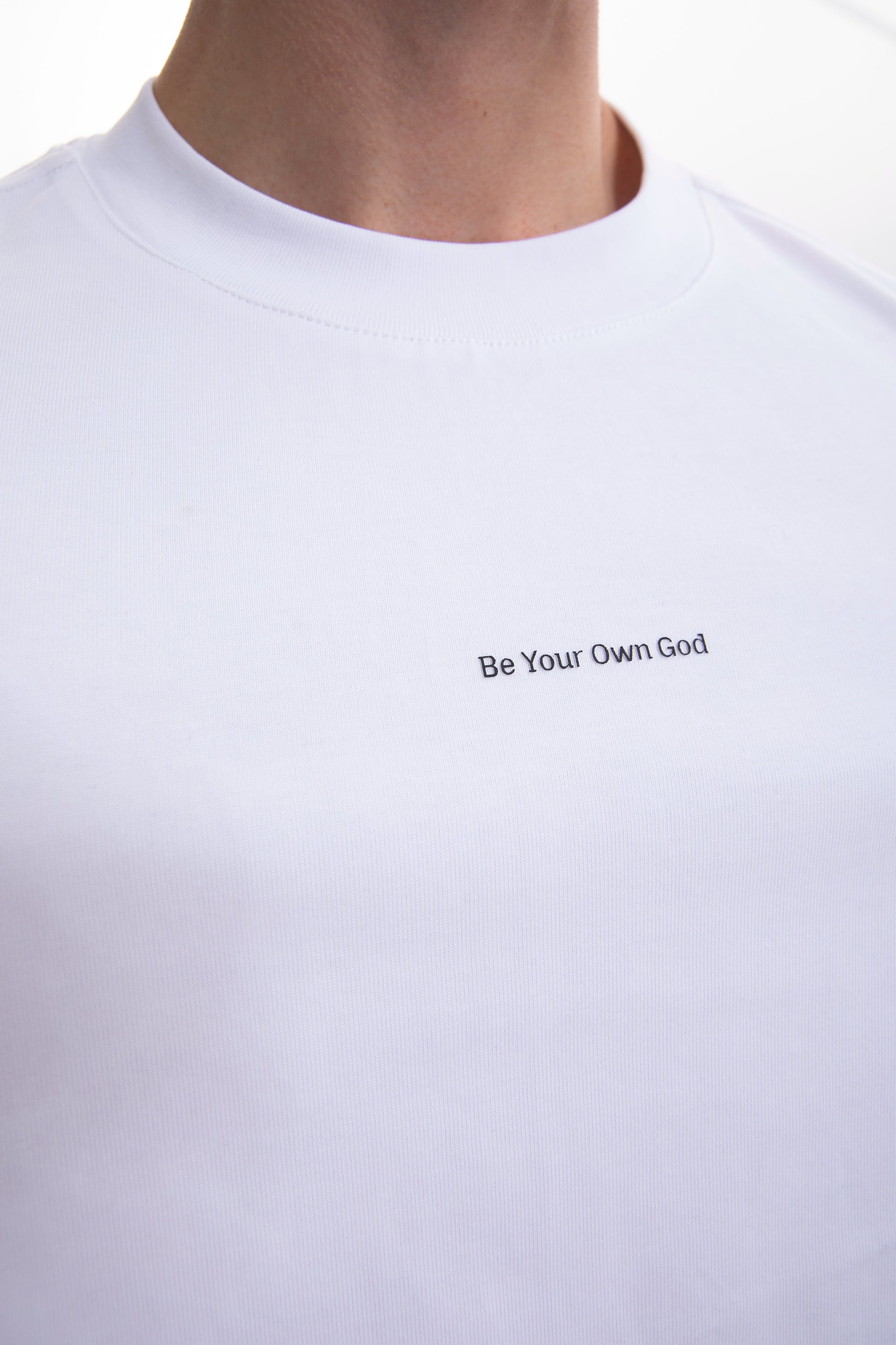 White t-shirt with 'Be Your Own God' text on a plain background