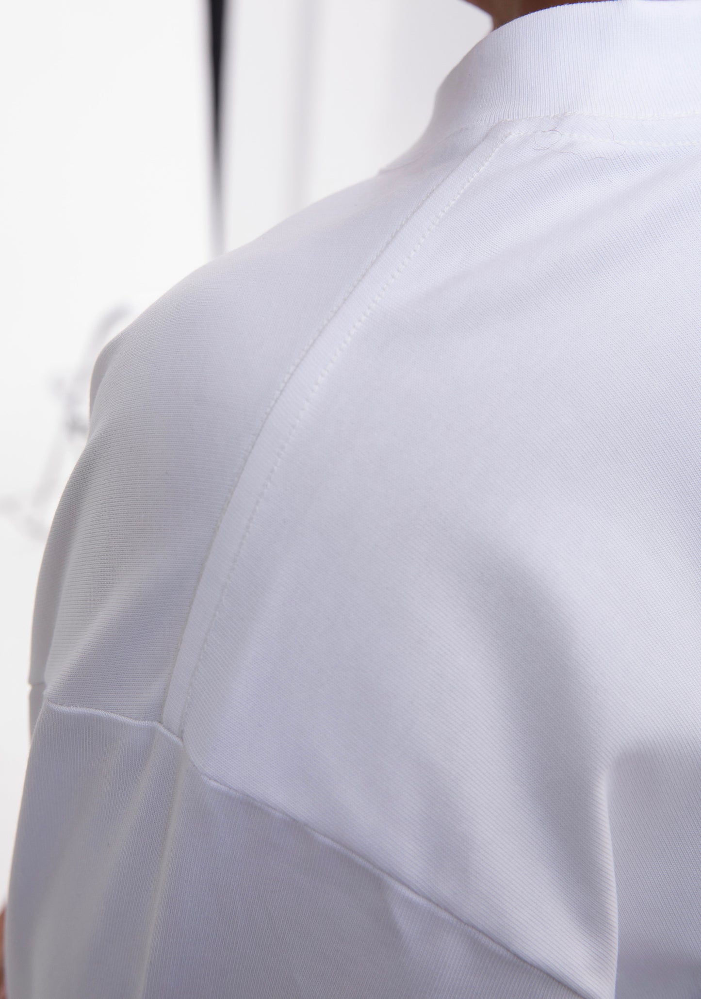 Close-up of a white shirt with a blurred background