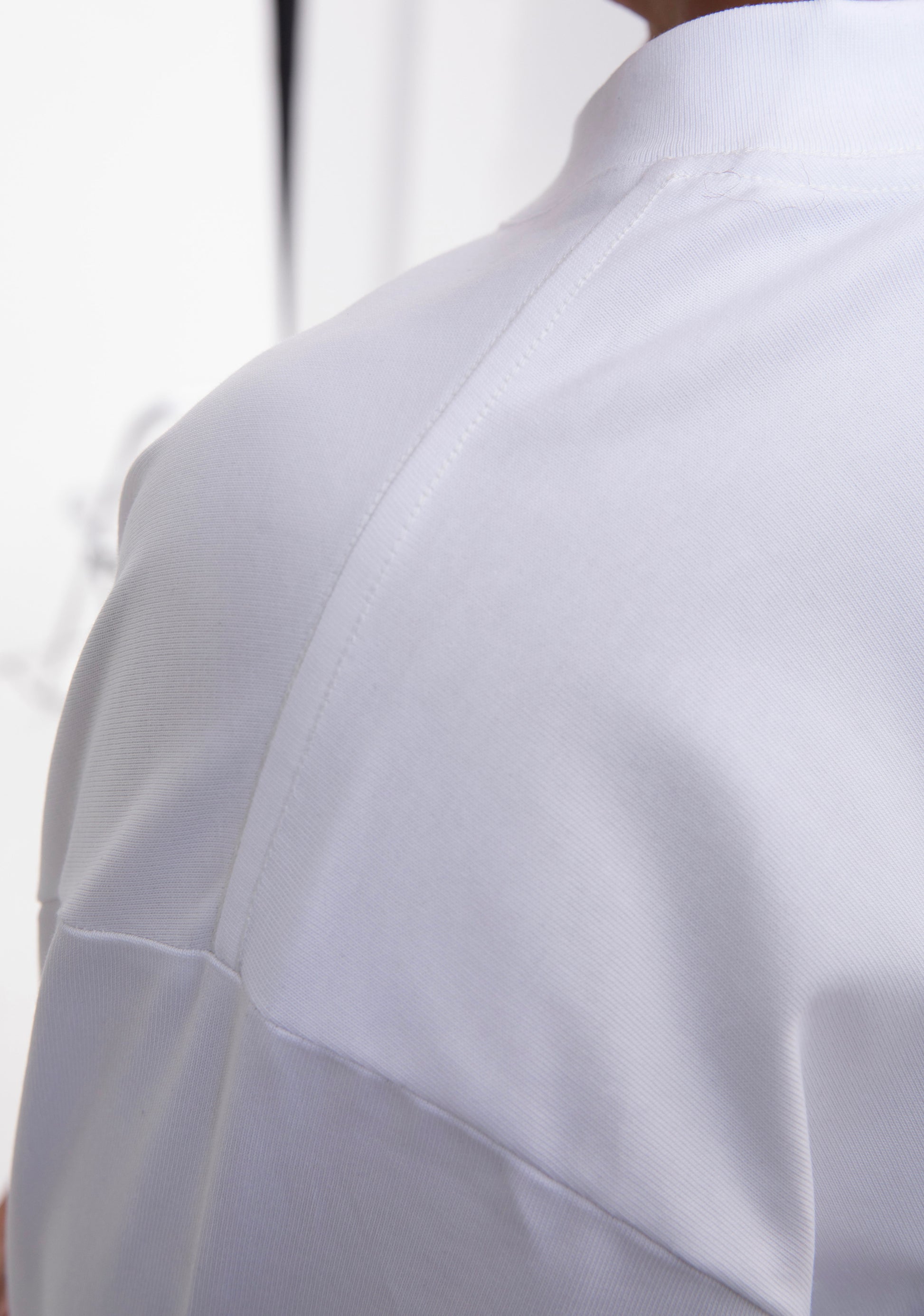 Close-up of a white shirt with a blurred background