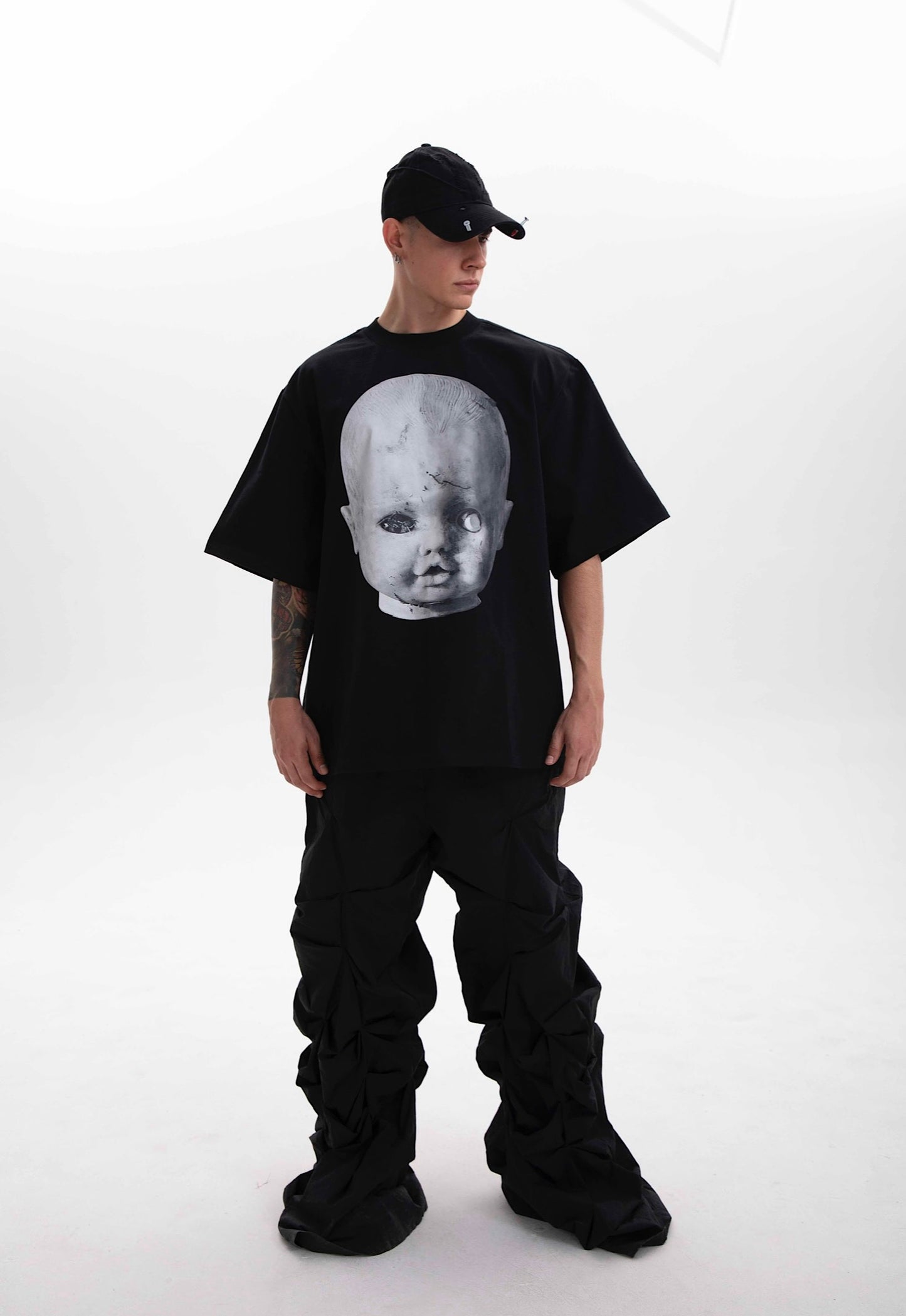 Model wearing the Baby Face black heavyweight t-shirt styled in dark aesthetic on a white background