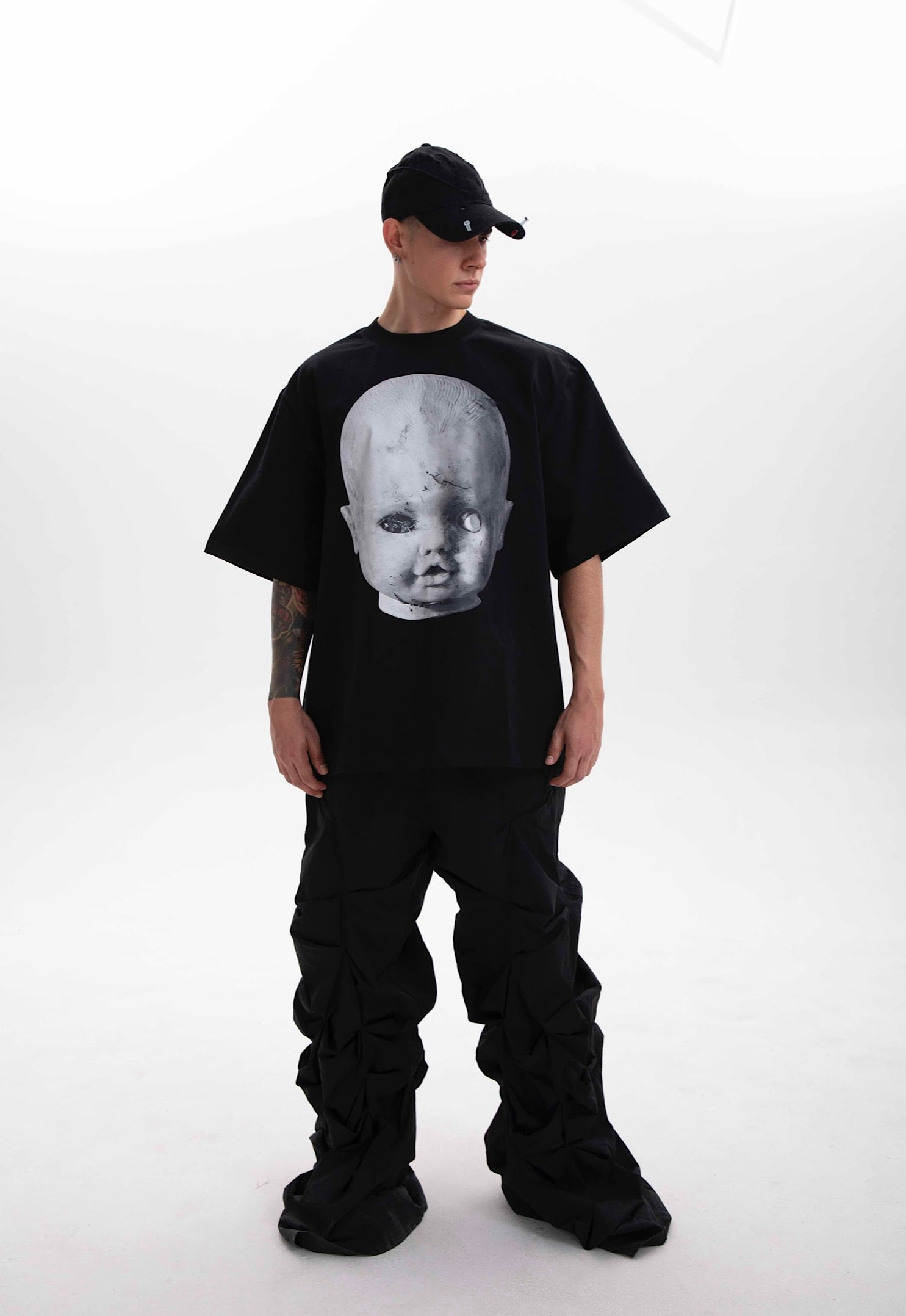 Model wearing the Baby Face black heavyweight t-shirt styled in dark aesthetic on a white background